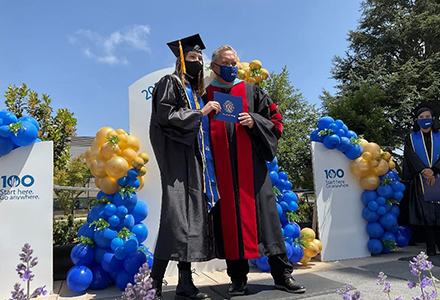 A graduate receiving her diploma from Superintendent/President Kevin G. Walthers, Ph.D.